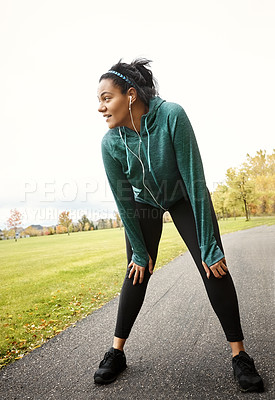 Buy stock photo Runner, woman and break in park with earphones, stop cardio workout or listening to music for recovery. Tired, female person and running rest outdoor with audio technology, breathe or pause exercise.