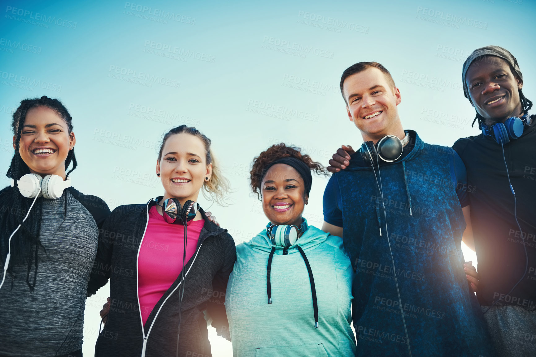 Buy stock photo People, friends and outdoor with hug for fitness, portrait or low angle with smile in summer. Group, runner and happy with embrace, diversity and sunshine with break, bonding and support for exercise
