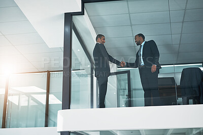 Buy stock photo Low angle, handshake and men in office, partnership for investment agreement or thank you. People, financial advisor or employees in workplace, shaking hands or trading deal for profit goals or smile