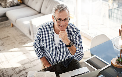 Buy stock photo Happy, laptop and portrait of mature man at desk for remote work, financial planning and budget review. House, above and person with smile for freelance career, finance manager and confident on break
