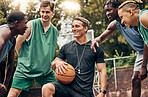 Basketball coach talking to his team during a training session on outdoor court. Teamwork, motivation and inspiration speech from trainer for basketball team having fun and learning in a sports game