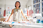 Portrait, fashion and designer with paper, drawing or sketch while planning style, tailor and texture in studio or workshop. Asian woman, smile and happy with career, small business or career vision 