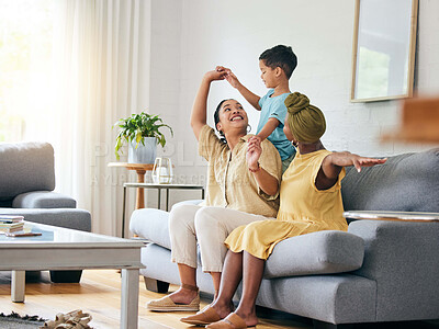Buy stock photo Family, lesbian couple and boy child on a sofa with airplane, game and fun in their home together. Love, lgbt and women mother in a living room with foster kid and piggyback, bond and play in house