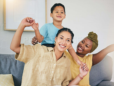 Buy stock photo Airplane, love and gay couple with boy child on a sofa for foster, bonding and playing in their home together. Lesbian, mothers and cheerful kid with parents in living room for piggyback fun games