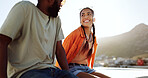 Summer, couple and rooftop date with happy, smile and relax woman and man talking, bonding and laughing. Love, sunset and interracial guy and lady enjoying the view of the city while flirting outdoor