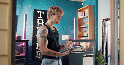 Buy stock photo Pen, small business and tablet with man in tattoo parlor for artistic design or creative planning. App, drawing and illustration with person in studio for ink or process of body art development