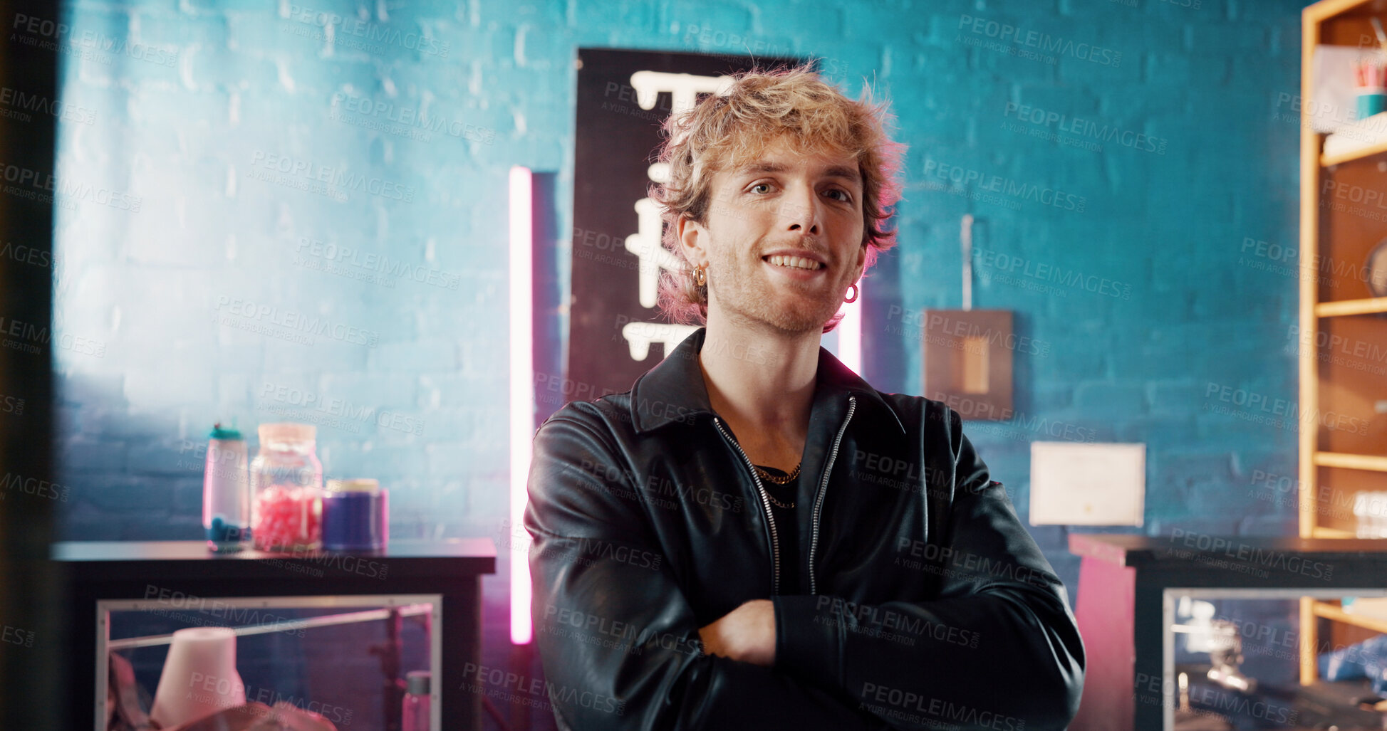 Buy stock photo Portrait, arms crossed and man in tattoo studio with smile, design and startup owner of parlor. Creative, professional and artist in store with confidence, about us and ink culture in small business.