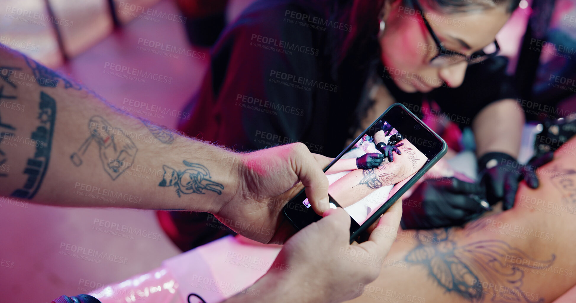 Buy stock photo Photography, phone screen or people at parlor with tattoo, aesthetic or ink culture for social media. Leg design, artist or creative at studio with mobile, art or website update for small business.