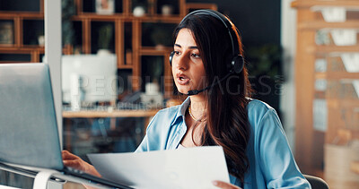 Buy stock photo Woman, headset and laptop with communication, documents and review for solution at media company. Person, consultant and virtual meeting with computer, problem solving and voip mic at creative agency