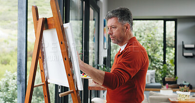 Buy stock photo Mature man, painter and canvas with easel for art, drawing or creative sketching in home. Male person, artistic or painting with brush or color palette for artwork, creativity or talent in house