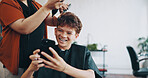 Haircut, phone styling with boy child at barbershop for appointment, consulting or treatment. Mobile, scissors and service with happy customer kid at hairdresser for maintenance, style or trim