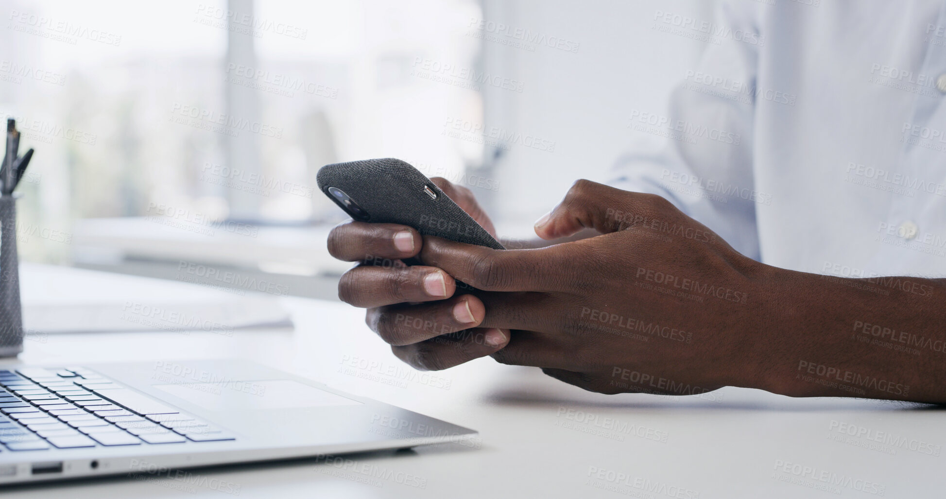 Buy stock photo Man, hands and typing in creative agency with phone, website or notification for social media marketing. Person, scroll and browsing in office with tech, mobile app and email for digital advertising.