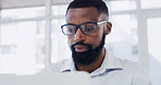 Glasses, laptop and reading with designer black man in office for online planning or research. Computer, eyewear and information with African design employee in creative workplace for development