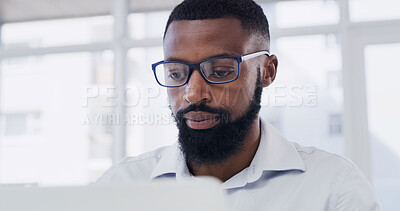 Buy stock photo Glasses, laptop and reading with designer black man in office for online planning or research. Computer, eyewear and information with African design employee in creative workplace for development