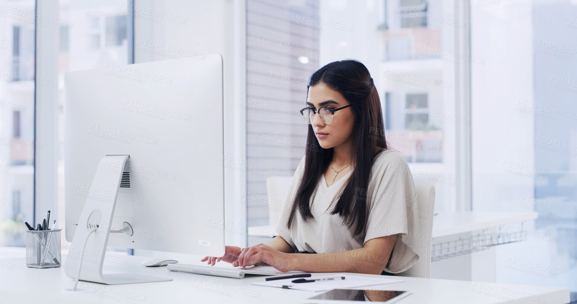 Buy stock photo Creative, woman and research in agency with computer, typing news report and story for journalism. Person, glasses and browsing in office with desktop, plan and editing article for media publication.
