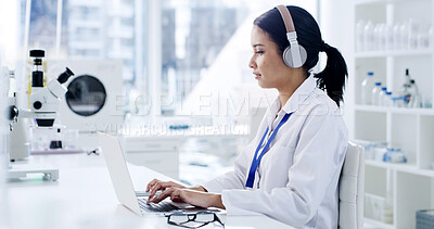 Buy stock photo Scientist, laptop and woman with headphones, typing and medical research for notes in laboratory. Podcast, doctor and report with chemist, test results or development with biotechnology study