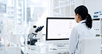 Back, woman and scientist with computer in lab for research, experiment and medical report. Female person, reading and pc screen with schedule, investigation results and information for vaccine study