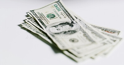 Buy stock photo Stack, money and dollars on table in studio for salary, financial fraud and embezzlement. Wages, notes and gambling for illegal cash, illicit funds and scam with income corruption on white background