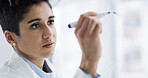 Woman, scientist and writing in laboratory for planning, experiment results or problem solving. Female person, healthcare worker or brainstorming with ideas for medical research on glass board