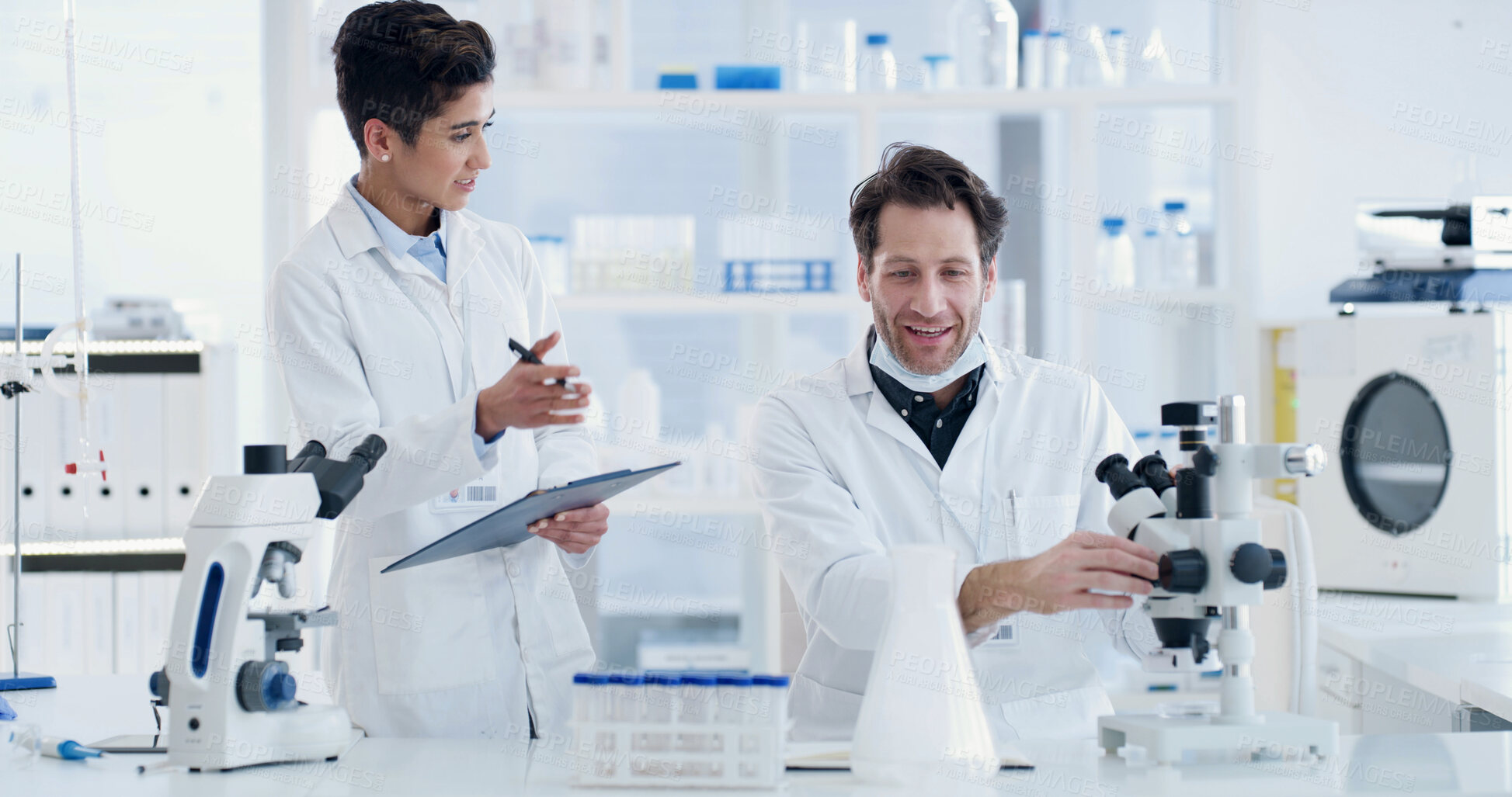 Buy stock photo Woman, scientist and team with clipboard at lab with microscope, happy or medical research for virus cure. People, science and man with review, checklist and feedback report for vaccine development