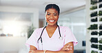 Doctor, woman and happy with arms crossed in clinic for pediatric help, medical service or about us. Pediatrician, black person or healthcare portrait in hospital for career trust or health integrity