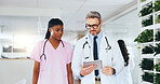 Healthcare, doctors and team with tablet in clinic for cardiac diagnostics, ECG results or planning. People, pediatrician and cardiologist with tech in hospital to review vital signs and EHR records
