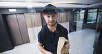 Delivery man, glass and package at front door with smile, service and ecommerce with pov in lobby. Happy person, courier and paper bag with order, online shopping and shipping with product in hallway
