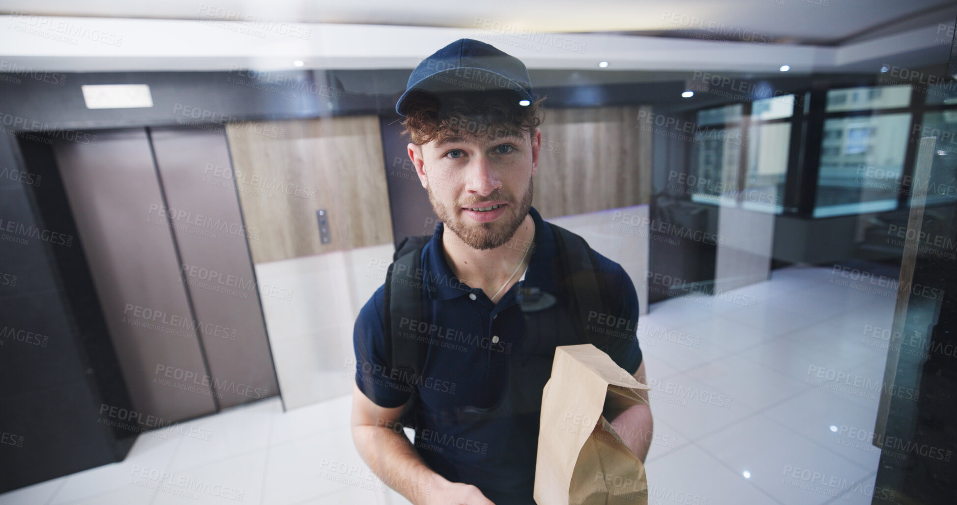 Buy stock photo Delivery man, glass and package at front door with smile, service and ecommerce with pov in lobby. Happy person, courier and paper bag with order, online shopping and shipping with product in hallway