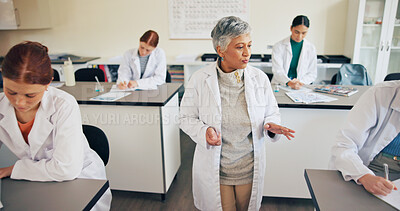 Buy stock photo Teacher, students or speaking in classroom for education, science lesson or explain chemistry experiment. Learn, people or teens writing notes for physics, knowledge or instruction for lab assessment