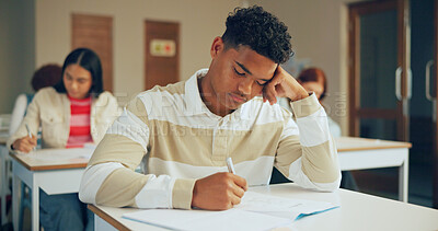 Buy stock photo Bored, tired and boy in high school with writing, learning issue or fatigue in study task. Mental health, notes and teenager in classroom with sleep, curriculum challenge or burnout for academic work