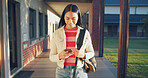 Phone, happy and student at school for education with networking, texting and contact on mobile app. Smile, technology and girl teenager with cellphone for communication at academy for learning.