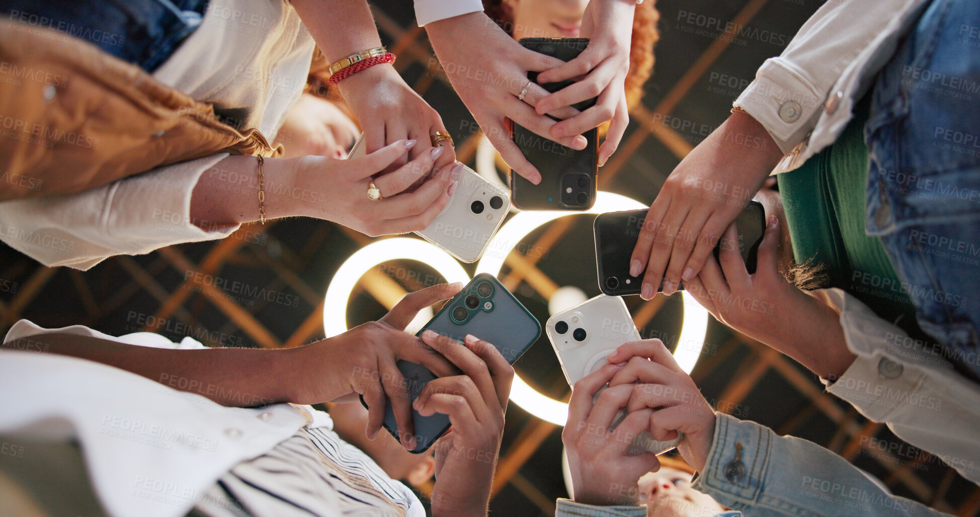 Buy stock photo People, hands or huddle with phone for network sharing, data sync or communication below. Low angle, group or creative community in circle with mobile smartphone or app for social media or connection