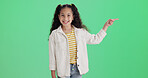 Green screen, pointing and girl with smile for portrait, promotion and opportunity for advertising. Space, marketing and happy child with offer in studio, announcement and sale message notification