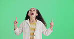 Excited, green screen and pointing with girl child in studio for announcement, news or notification. Advertising, enthusiasm and marketing with female kid isolated on mockup space for update message