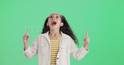 Buy stock photo Excited, green screen and pointing with girl child in studio for announcement, news or notification. Advertising, enthusiasm and marketing with female kid isolated on mockup space for update message