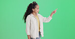 Green screen, child and girl with smile for pointing, promotion and opportunity for advertising. Mockup space, marketing and happy kid with discount offer in studio, announcement and brand sale