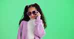 Girl, portrait and studio with sunglasses for fashion, style or outfit on a green background. Child, kid or model with frame or cool assessory for eyesight, vision or casual clothing on mockup space