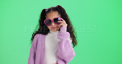 Buy stock photo Girl, portrait and studio with sunglasses for fashion, style or outfit on a green background. Child, kid or model with frame or cool assessory for eyesight, vision or casual clothing on mockup space