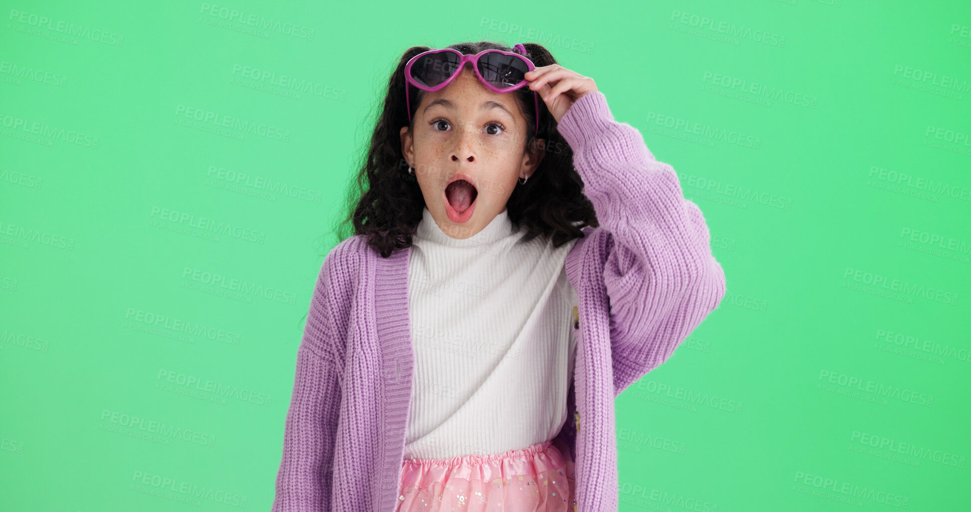 Buy stock photo Girl, portrait and studio with surprise for rumor, gossip or secret on a green background. Child, kid or shocked with sunglasses, wow or expression for alert, notification or OMG reaction on space