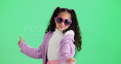 Buy stock photo Dance, kid and sunglasses on green screen with smile, space and casual fashion in studio. Child, shades and moving to music with rhythm, stylish accessory and cool girl with happiness on background