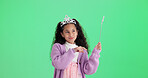 Happy girl, thinking or wand with costume in studio for halloween party on a green background. Thoughtful child, kid or princess with fairy tale outfit, fashion or style for magic wish or cosplay