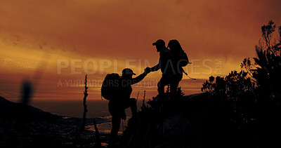 Buy stock photo Climbing, help and hiking with silhouette of people outdoor in mountains at sunset for fitness or hobby. Health, teamwork and wellness with hiker friends in nature together for adventure and travel