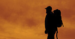 Sunset, hiking and silhouette of man outdoor for adventure, reflection and vacation with view. Trekking, backpacking and person in nature for holiday, travel or thinking with clouds for sightseeing