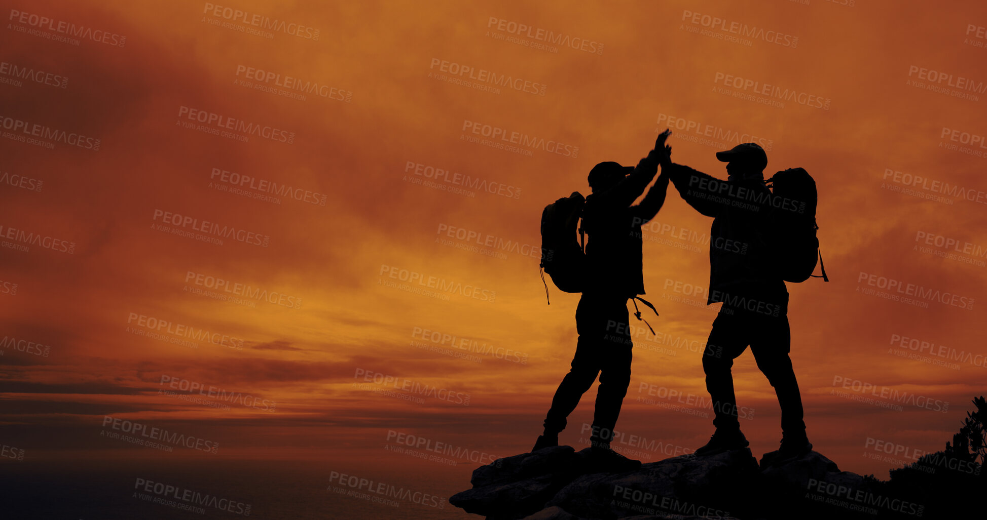 Buy stock photo Sunset, silhouette and friends with high five for hike on mountain for vacation, adventure or holiday. Space, sky and shadow of men with celebration for backpacking goal on weekend trip for trekking.