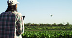 Agriculture, farm and woman with drone to monitor crops, field mapping and space in nature. Outdoor, person and farmer with flying tech for agro management, plants and growth of vegetables from back