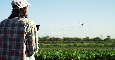 Buy stock photo Agriculture, farm and woman with drone to monitor crops, field mapping and space in nature. Outdoor, person and farmer with flying tech for agro management, plants and growth of vegetables from back