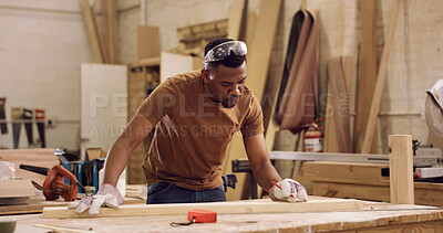 Buy stock photo Carpentry, planning and black man with measuring wood in workshop for furniture development with precision. Tools, timber and African male carpenter with plank for woodworking or handicraft project.