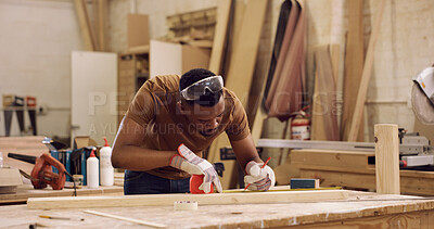 Buy stock photo Carpentry, writing and black man with tape measure in workshop, construction process and precision. Tools, woodworking and carpenter with plank for creative project, material preparation and craft
