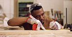 Carpenter, writing and black man with tape measure in workshop, construction process and precision. Tools, carpentry and woodworker with plank for creative project, material preparation and craft