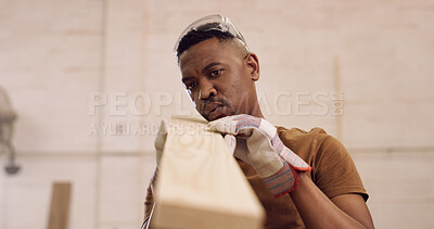 Buy stock photo Carpenter, man and blowing in factory with woodwork, remodeling project and furniture production. Space, black person and timber with dust, craftsmanship and inspection for carpentry manufacturing.